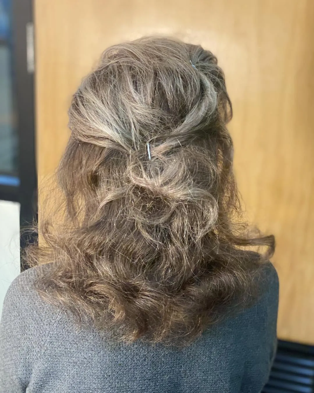 Back of a client's head — silver wavy blow-dry and wig-restore result