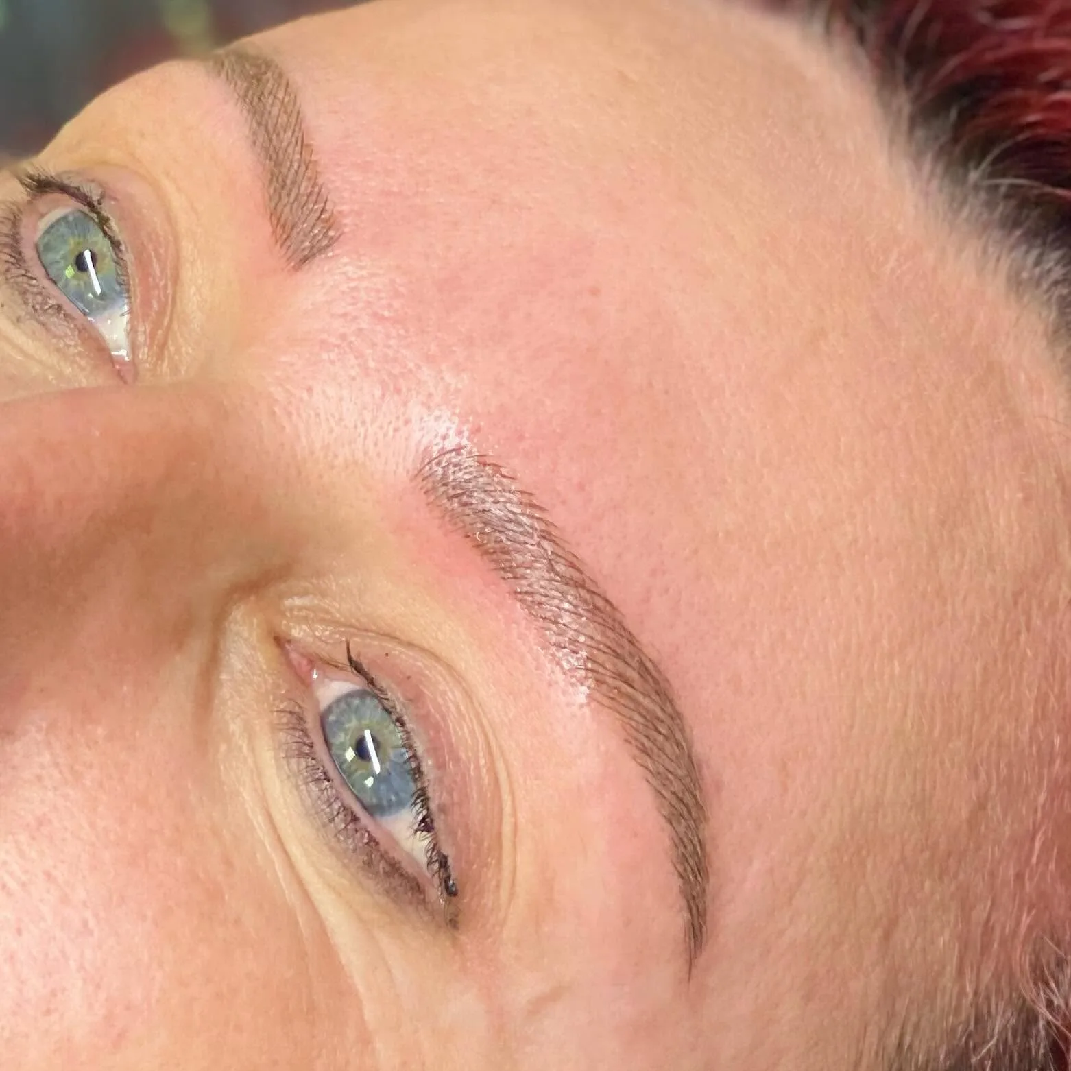 Red-haired client with green eyes and crisp hair-stroke brows